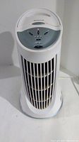 Front side view of white Honeywell air purifier tower fan showing ventilation grille and base.