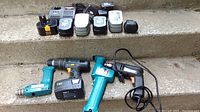 Overview photo showing multiple power tools, batteries, and chargers arranged on steps.