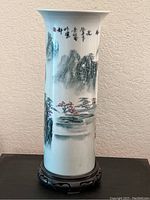 Front and side views of the 15x5 inch Far East motif cylindrical vase showing landscape painting and calligraphy.