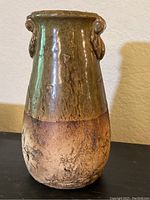 Front view of hand thrown pottery vase showing glaze and textured base.