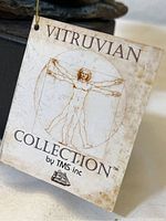 Close-up image of the Vitruvian Collection tag showing the title and collection by TMS Inc.