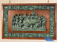Full view of the framed wood and resin wall art showing The Last Supper with a decorative carved border.
