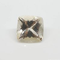 Close-up image of square cushion champagne morganite showing facets and internal inclusions.