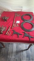 Photo showing all metal pieces on table, including finials, brackets, circular rings, and dog figures
