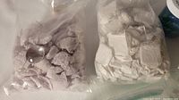 Plastic bags filled with assorted glass beads and small stones wrapped in white tissue