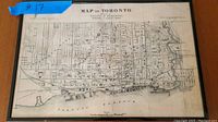 Full front view of the framed 1878 Toronto map showing the entire map with visible detail of streets and topography.