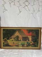 Full view of the framed art piece showing the entire rural farm scene with barn, animals, and people.