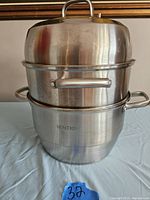 Full assembled food steamer with lid on top showing the stacked layers and pot base.