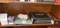 Shelf view showing multiple boxes and albums of baseball cards in storage