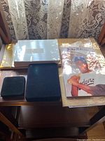 Photo of the baseball memorabilia lot displaying multiple stacked cards and a large Jackie Robinson card with a bat.