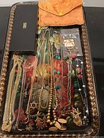 Tray of assorted gold chains, pendants and bag of rings