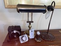 Lot contents showing 3 lamps, timer, and Franz metronome on surface