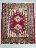 Full top view of the Turkman hand knotted wool rug with geometric medallion and border pattern.
