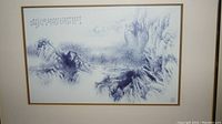 Framed Asian landscape print with blue brush art and calligraphy text.