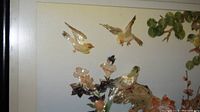 Close-up of upper section showing shell birds in flight and part of the floral arrangement in shadow box.