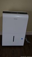 Front view of the white Danby dehumidifier showing control panel and water level indicator window.