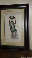 Framed wax figure portrait of princess in traditional dress, full view