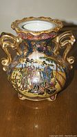 Full frontal image of the Satsuma vase showing shape, handles, rim, and central painted scene