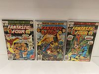 Three Fantastic Four comics issues 181, 185, 187 in protective sleeves showing cover artwork with characters and titles