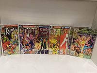 Front view of Fantastic Four comic books Issues 230 to 234 and 238 to 239 displayed upright and angled showing cover art.