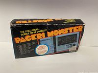 Box front showing Packri Monster branding, game image, and features including bright fluorescent yellow and red colors with sound and action.
