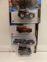 Front view of four Hot Wheels Batmobile die-cast cars in original packaging, showing Classic TV Series branding