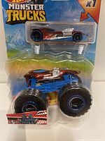 Front view of Hot Wheels Monster Trucks set with both vehicles visible in blister packaging on colorful card.