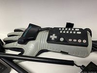 Close-up of Nintendo Power Glove controller showing buttons and glove detail