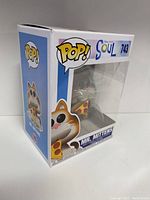 Front and side view of the Mr. Mittens POP figure in original packaging showing the figure holding a pizza slice, with clear display window and branding details.