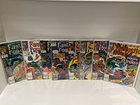 Photo showing nine Marvel Comics Fantastic Four issues from Vol. 1 with colorful vintage comic covers, including issues in the 310s series as per the description.