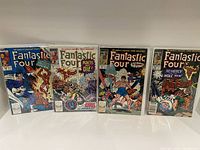 Four vintage Marvel Fantastic Four comic books from 1977 displayed upright showing full front covers.