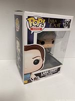 Front view of the original box showing the Lara Croft figure, number 168 with POP! Games branding and character face close-up illustration.