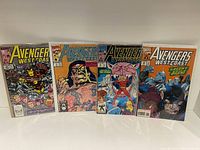 Four West Coast Avengers comic books laid out side by side showing full covers.
