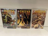 Three Sheena Dark Rising comic books displayed upright inside protective sleeves.