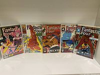 Five Fantastic Four comic books in plastic sleeves, arranged in a row.