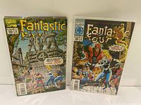 Two Fantastic Four comic books, issues #388 and #389, in plastic sleeves, showing full front covers.