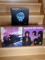 Front covers of three Deep Purple vinyl records showing distinct album artwork and titles