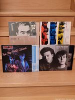 Front view of 4 vinyl albums including '18', The Police 'Synchronicity', Soft Cell 'Non-Stop Erotic Cabaret', and Tears For Fears 'Songs From The Big Chair'.