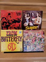 Front covers of four vinyl LP records by Slade and Iron Butterfly showing album artwork