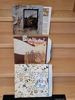Photo showing front covers of Led Zeppelin IV, II, and III vinyl records.