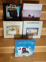 Photo showing five vinyl LPs including The Plumbers, Catch Bull at Four, Tea for the Tillerman, two other Cat Stevens albums