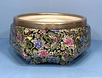 Front angled view of 1930s Royal Winton Grimwades porcelain bowl showing colorful floral and butterfly pattern with gold trim.