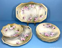 Full set displayed showing tray, bowls, and plates with floral decoration