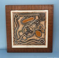 Framed lithograph showing full artwork and textured wood frame.