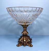 Front view showing the crystal bowl and ornate brass pedestal base.