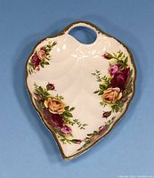 Front view of the porcelain leaf-shaped trinket dish with Old Country Roses floral pattern and gold trim