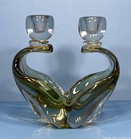 Front view of the vintage two-arm art glass candle holder showing clear and amber tinted glass with curved elegant design, holding two candle cups.