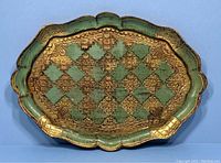 Full view of the vintage green and gold Italian Florentine tray showing scalloped edges and pattern.