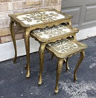 Set of 3 vintage Italian Florentine nesting tables shown nested together on pavement.
