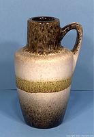 Front view of the vintage West German small handled vase with multicolor glaze and single handle.
